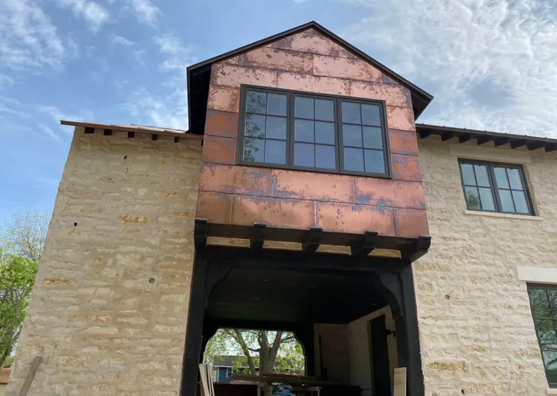 Copper metal panel facade on a stone building for Skylight Installation in Southold