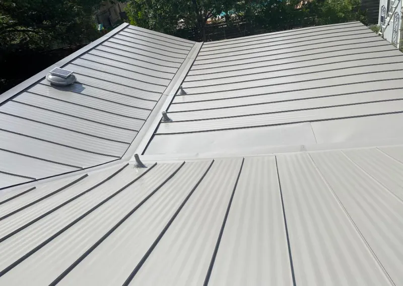 Solar attic fan installed on a metal roof for Roof Ventilation in Southold